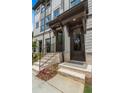 Townhome entrance with brick steps, dark brown door, and black railing at 1084 Battery Park Rd, Decatur, GA 30033