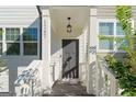 Gray front door entry with white columns and porch at 1267 Carbon Ct, Atlanta, GA 30316