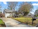 Ranch home with a long driveway and a fenced yard at 517 Woodrow Ave, Atlanta, GA 30354