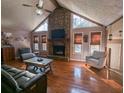 Spacious living room with hardwood floors, stone fireplace, and vaulted ceiling at 5491 Deerfield Nw Pl, Kennesaw, GA 30144