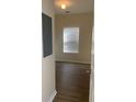 Simple bedroom with wood flooring and a window with blinds at 539 Greyhawk Way, Fairburn, GA 30213
