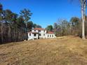 New home construction, red tile roof, and wooded lot at 515 Penny Ln, Loganville, GA 30052
