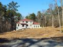 House under construction, red roof, and wooded setting at 515 Penny Ln, Loganville, GA 30052
