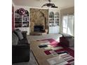Spacious living room with a stone fireplace and built-in shelves at 4365 Miners Creek Rd, Lithonia, GA 30038