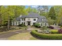 Stunning two-story home nestled on a wooded lot with circular driveway at 6092 Carlisle Ln, Alpharetta, GA 30022