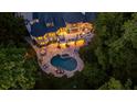 Luxury home with a large backyard, pool, and lush landscaping at 6092 Carlisle Ln, Alpharetta, GA 30022
