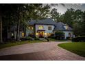 Elegant two-story home with a grand entrance and manicured lawn at 6092 Carlisle Ln, Alpharetta, GA 30022