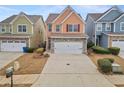 Two-story townhome with stone accents and a two-car garage at 7167 Rigel Sw Bnd, Atlanta, GA 30331