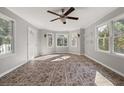 Bright sunroom with tile flooring and a ceiling fan at 4129 Duesenberg Dr, Tucker, GA 30084