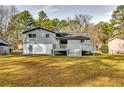 Spacious backyard with a deck and a large grassy area at 6685 Buckhurst Trl, Atlanta, GA 30349