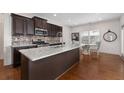 Modern kitchen featuring granite island and dark cabinetry at 2325 Button Head Nw Run, Kennesaw, GA 30144