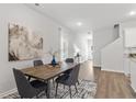 Dining room with a wooden table, four chairs, and an open floor plan at 713 Cygnet Ln, Grayson, GA 30017