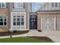 Elegant home entry with iron gate and brick walkway at 2733 Caldwell Rd, Brookhaven, GA 30319