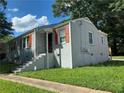 Gray brick ranch home with orange shutters, steps, and a landscaped lawn at 723 Casplan St Sw, Atlanta, GA 30310