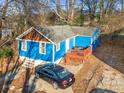Blue house with wooden deck and car in driveway at 271 Andrew Hairston Nw, Atlanta, GA 30314