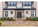 Townhome building entrance with brick facade and landscaping at 3933 Danube Ln # 224, Atlanta, GA 30339