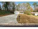 House on a hill with a large yard and driveway at 5862 Homestead Cir, Rex, GA 30273