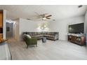 Spacious living room featuring a large sectional sofa and stylish decor at 5862 Homestead Cir, Rex, GA 30273