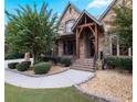 Brick and stone front porch with landscaping and walkway at 1255 Mcminn Way, Snellville, GA 30078