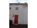 Front view of a tan colored townhouse with red door at 237 Chads Ford Way, Roswell, GA 30076