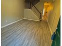 Spacious living room with gray vinyl plank flooring and staircase at 230 Valley Xing, Canton, GA 30114