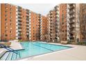 Community swimming pool with surrounding patio furniture at 300 Johnson Ferry Rd # B711, Atlanta, GA 30328