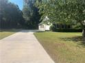 Long driveway leading to a charming house with green lawn at 177 Simeon Dr, Mcdonough, GA 30252