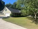 House exterior showcasing a two-car garage and mature trees at 177 Simeon Dr, Mcdonough, GA 30252