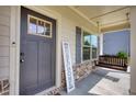 Front door entrance with a porch swing and rocking chairs at 3109 Bentley Farms Dr, Loganville, GA 30052