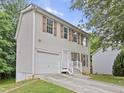 Two-story house with attached garage and a driveway at 4127 Conley Pond Ct, Decatur, GA 30034