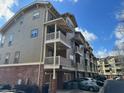 Three-story building with brick and siding, balconies, and attached garages at 655 Mead St # 28, Atlanta, GA 30312