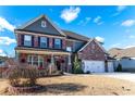 Two-story home with a three car garage, brick facade, and front yard at 1178 Fort Marcy Park, Lawrenceville, GA 30044