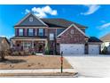 Two-story home with 3-car garage, landscaping, and large front yard at 1178 Fort Marcy Park, Lawrenceville, GA 30044