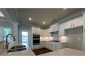 Modern kitchen with white cabinets, stainless steel appliances, and quartz countertops at 1999 Gladys Ct, Marietta, GA 30064