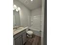 Bathroom with granite countertop vanity, tub, and gray flooring at 3233 Greenhill Dr, Villa Rica, GA 30180