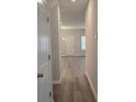 Bright hallway with light gray walls and wood-look flooring at 3233 Greenhill Dr, Villa Rica, GA 30180