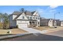 Two-story home with gray siding, stone accents, and a three-car garage at 739 Marlay Sw Ln, Powder Springs, GA 30127