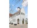 White brick home with a charming red tile roof at 11273 Serenbe Ln, Chattahoochee Hills, GA 30268