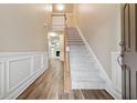 Two-story entryway with hardwood floors and a carpeted staircase at 2368 Harshaw Ave # 166, Lawrenceville, GA 30043