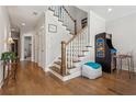 Game room with hardwood floors, staircase, and arcade game at 5499 Vineyard Park Trl, Norcross, GA 30071