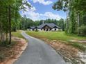 Luxury home with long driveway and large green lawn at 530 Penny Ln, Loganville, GA 30052