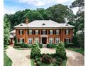 Grand brick home with a large circular driveway and mature trees at 3370 Habersham Nw Rd, Atlanta, GA 30305