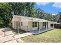 Newly renovated ranch home with covered porch and fenced yard at 4218 Tara Dr, Forest Park, GA 30297