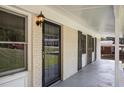 Inviting front porch with brick exterior and dark shutters at 4218 Tara Dr, Forest Park, GA 30297