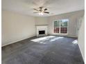 Spacious living room featuring a corner fireplace and carpet flooring at 2491 Emma Way, Lawrenceville, GA 30044
