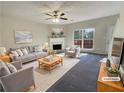 Virtually staged living room with fireplace and large windows at 2491 Emma Way, Lawrenceville, GA 30044