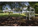 Charming ranch house with a porch and well-manicured yard at 445 Hinton Rd, Social Circle, GA 30025