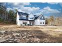 Two-story house with white and gray siding, a large front yard, and a spacious driveway at 1833 Tommy Lee Cook Rd, Palmetto, GA 30268