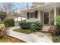 Front entrance with steps leading to the front door and neatly trimmed shrubbery at 3027 Saint Annes Nw Ln, Atlanta, GA 30327