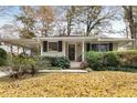 House exterior showcasing a covered porch and well-maintained lawn at 3027 Saint Annes Nw Ln, Atlanta, GA 30327